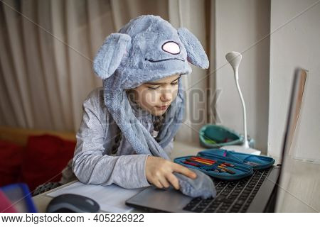 Distant Education, Online Class Meeting. Girl Wearing Funny Hat For Amusement During Online Lesson