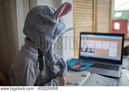 Distant Education, Online Class Meeting. Girl Wearing Funny Hat For Amusement During Online Lesson