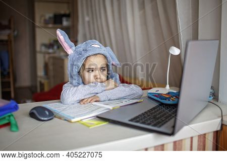 Distant Education, Online Class Meeting. Girl Wearing Funny Hat For Amusement During Online Lesson