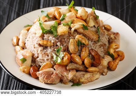Authentic Cinnamon And Ground Beef Rice Recipe Topped With Chicken And Nuts Close-up In A Plate. Hor