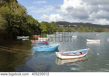 Fishing Boats Moored In A Peaceful Seascape Near The Village Of Ladrido, In The Ortigueira Estuary, 