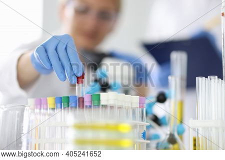 Female Chemist In Protective Rubber Gloves Holding Test Tube In Laboratory Closeup. Pharmaceutical I
