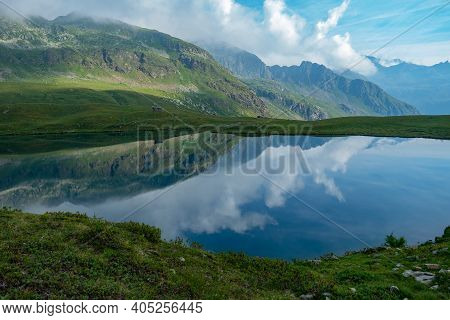 Lago Di Malghera In The Italian Alps: Beautiful Reflections Of Mountains And Sky