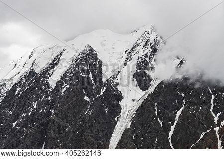 Atmospheric Minimalist Alpine Landscape With Massive Hanging Glacier On Snowy Mountain Peak. Big Bal