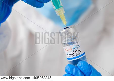 Curevac Coronavirus Vaccine And Syringe In The Bottle Or Vial For Injection In Doctors Hands. Covid-