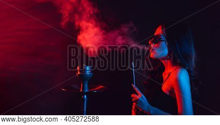 Hookah Atmosphere. The Girl Enjoys Smoking A Hookah, Sheesha. Place For Your Text