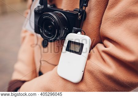 Tourist Using Wireless Digital Audio Tour Guide Equipment With Earphones. Man Traveler Goes Sightsee