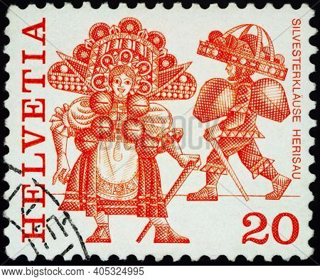 Moscow, Russia - January 20, 2021: Stamp Printed In Switzerland Shows New Year's Eve Costumes, Heris