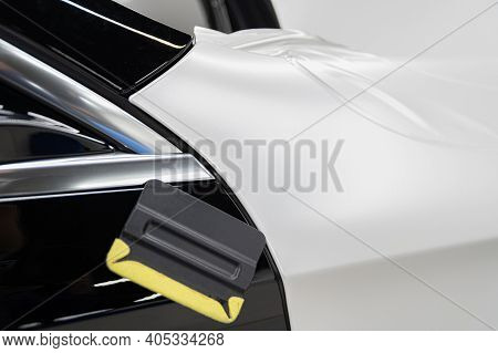 Wrapping The Car With Self-adhesive Foil. Changing Car Color