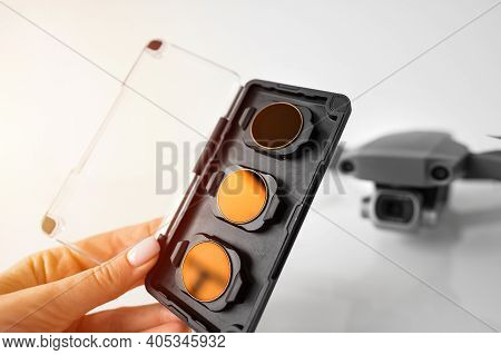 Female Hand Holding Nd Filters And Polarising Filters Set For Drone. Filters For The Drone Camera.