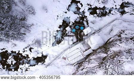 Hot Springs In The Snowy Forest And Mountains. Top View From The Drone On The White Gorge With The R