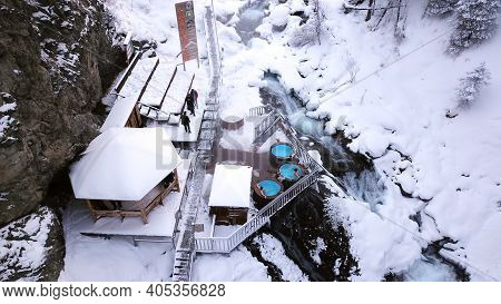 Hot Springs In The Snowy Forest And Mountains. Top View From The Drone On The White Gorge With The R