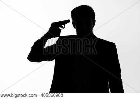 Shadow Of A Man With A Gun In His Hands Aiming Detective Crime Light Background