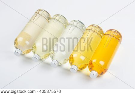 Collection Transparent Lying Bottles With Different Pale Colors Liquid, Cosmetic Product, Perfume Or
