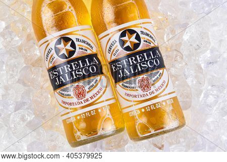 IRVINE, CALIFORNIA - MARCH 21, 2018: Two bottles of Estrella Jalisco Beer in ice closeup. Estrella Jalisco is a American Lager style beer brewed by Grupo Modelo.