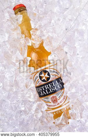IRVINE, CALIFORNIA - MARCH 29, 2018: Closeup of a bottle of Estrella Jalisco beer in ice.  Estrella Jalisco is a American Lager style beer brewed by Grupo Modelo.