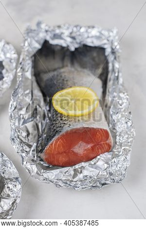 Fresh Raw Salmon Fillet Tail Part With Lemon On A Light Background. Pescatarian Food Menu, Recipe. R