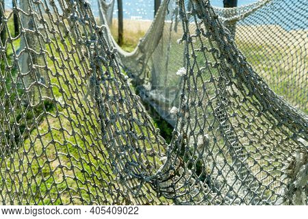 Fishing Seine.selective Focus. Old Net For Catching Fish And Seafood. Tackle Is Dried In The Sun