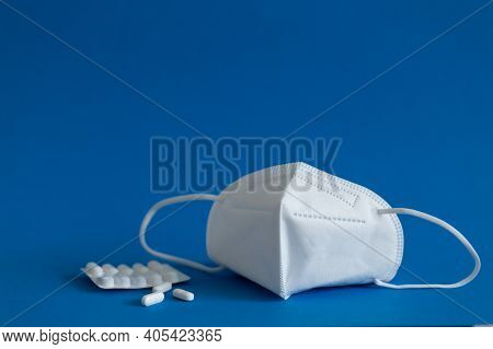 Ffp3 Mask, Nasal Drops, Thermometer, Tablets, Various Medicines Lie On The Table, Top View, On A Blu