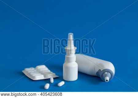 Ffp3 Mask, Nasal Drops, Thermometer, Tablets, Various Medicines Lie On The Table, Top View, On A Blu