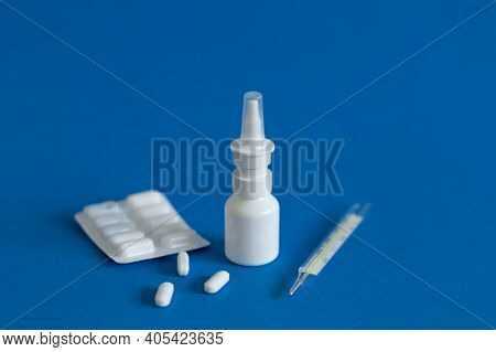 Ffp3 Mask, Nasal Drops, Thermometer, Tablets, Various Medicines Lie On The Table, Top View, On A Blu