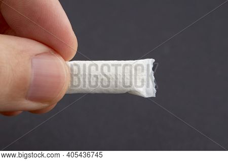 Caucasian Person Holds Snus Tobacco Pouch Over Black Background. Copy Space. Alternative Chewing Nic