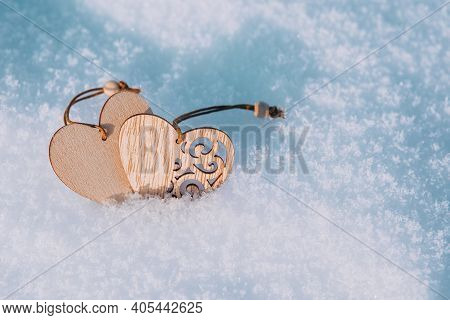 Couple Of Wooden Hearts In Cold, Frosty Morning Snow. Valentines Day Greeting Card. Symbol Of Love A