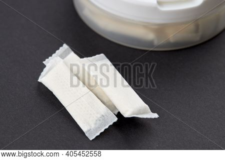 Snus Tobacco Pouch Product Over Black Background. Copy Space. Alternative Chewing Nicotine Smoking.