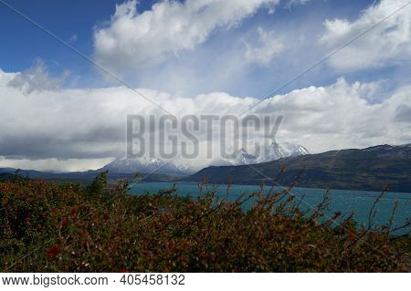 Horns Of Torres Del Paine Towering Over The Turquoise Water Of Lake Pehoe And A Mountain Ridge With 