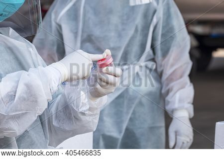 Outdoor Health Workers In Ppe Clothing Are Collecting Sputum And Saliva Samples To Detect Covid-19 I