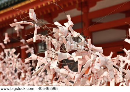 Kyoto, Japan - April 19, 2012: Omikuji Paper Fortunes Tied To A Tree At Heian Jingu Shrine In Kyoto,