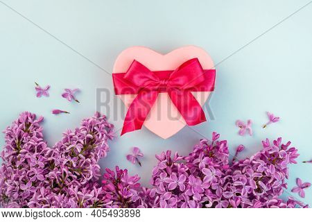 Pnk Heart Shape Gift Box With Red Ribbon Bow, Purple Lilac Branch Flower Blooming Bouquet On Blue Ba