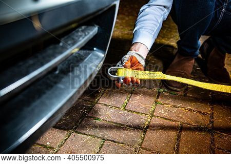 A Male Hand Attaching A Towline To A Car.