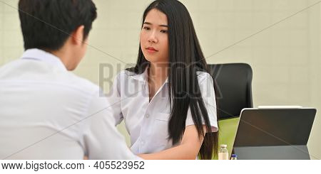 Cropped Image Of Medical Students Comforting Together While Sitting At Wooden Working Desk Over Comf