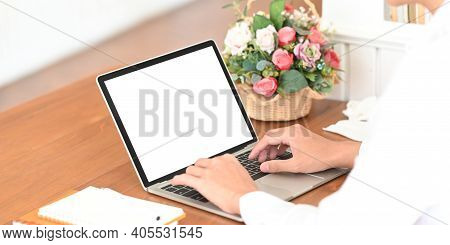 Cropped Image Of Smart Man's Hands Typing On Computer Laptop With White Blank Screen That Putting On