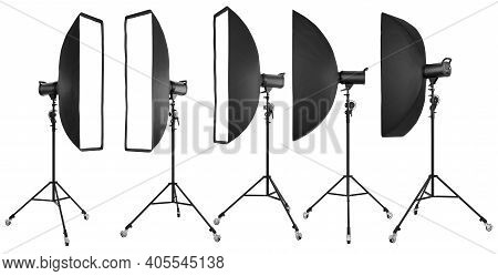 Photo Studio Lighting Stands With Flash And Softbox Isolated On The White.