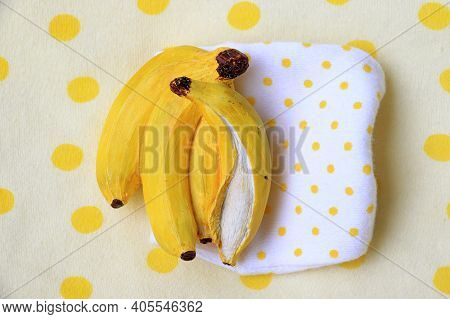 A Banana Resin Miniature On A Dotted Picnic Background.