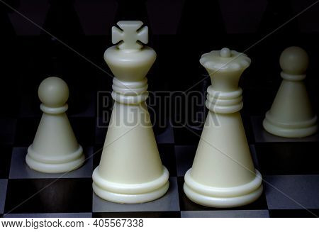 An Image Of Black And White Chess Pieces On A Chessboard.