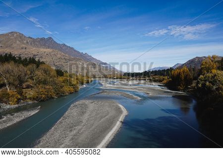 Bridge Over A Clear River In The Mountains