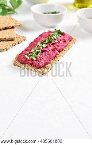 Homemade Beet Hummus On Bread Over White Stone Background With Freee Text Space. Vegetarian Vegan Fo
