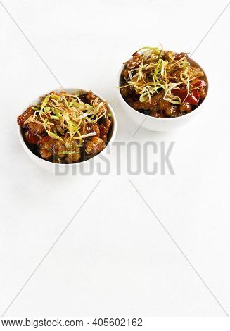 Spicy Garlic Fried Chicken (kkanpunggi). Asian Chicken In Sweet And Sour Sauce In Bowl Over White Ba