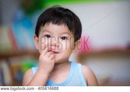 Close-up. An Asian Boy Uses His Hand To Eat Food In His Mouth. Concept Of Health Care, Disease Occur