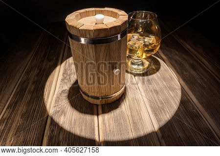 Mini Oak Barrel For Making Homemade Whiskey, And A Glass With Ice. Spotlight