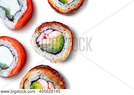 Sushi background. Sushi pattern with fresh salmoon and eel rolls on white background. Round folding rolls. Fresh roll pieces. Sushi roll isolated on white background
