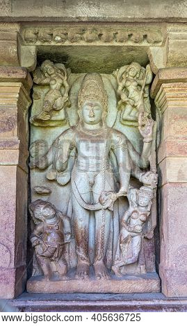 Aihole, Karnataka, India - November 7, 2013: Durga Gudi Or Temple. Gray Stone Statue Of Male God Wit