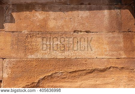 Aihole, Karnataka, India - November 7, 2013: Lad Khan Temple. Closeup Of Ancient Script Chiseled Int