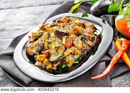 Ragout With Eggplant And Pepper On Black Wooden Board