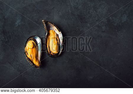 Large Mussels On A Black Background. Top View With Space For Text.