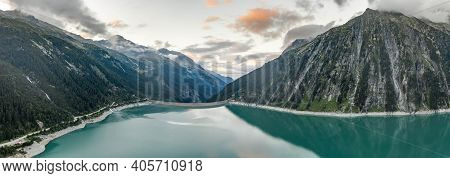 Aerial Drone Shot Of Schlegeisspeicher Resevoir With Galcier View At Dusk