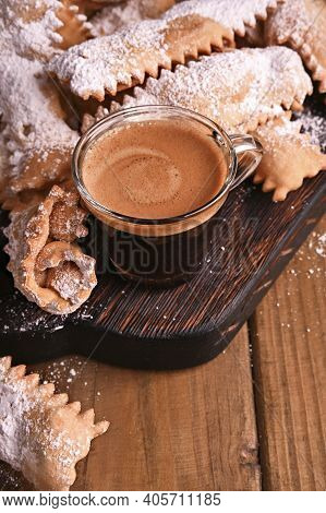 Carnival Food Typical And Aromatic Coffee. Sfrappole Or Chiachiere Or Angel Wings On A Woody Backgro